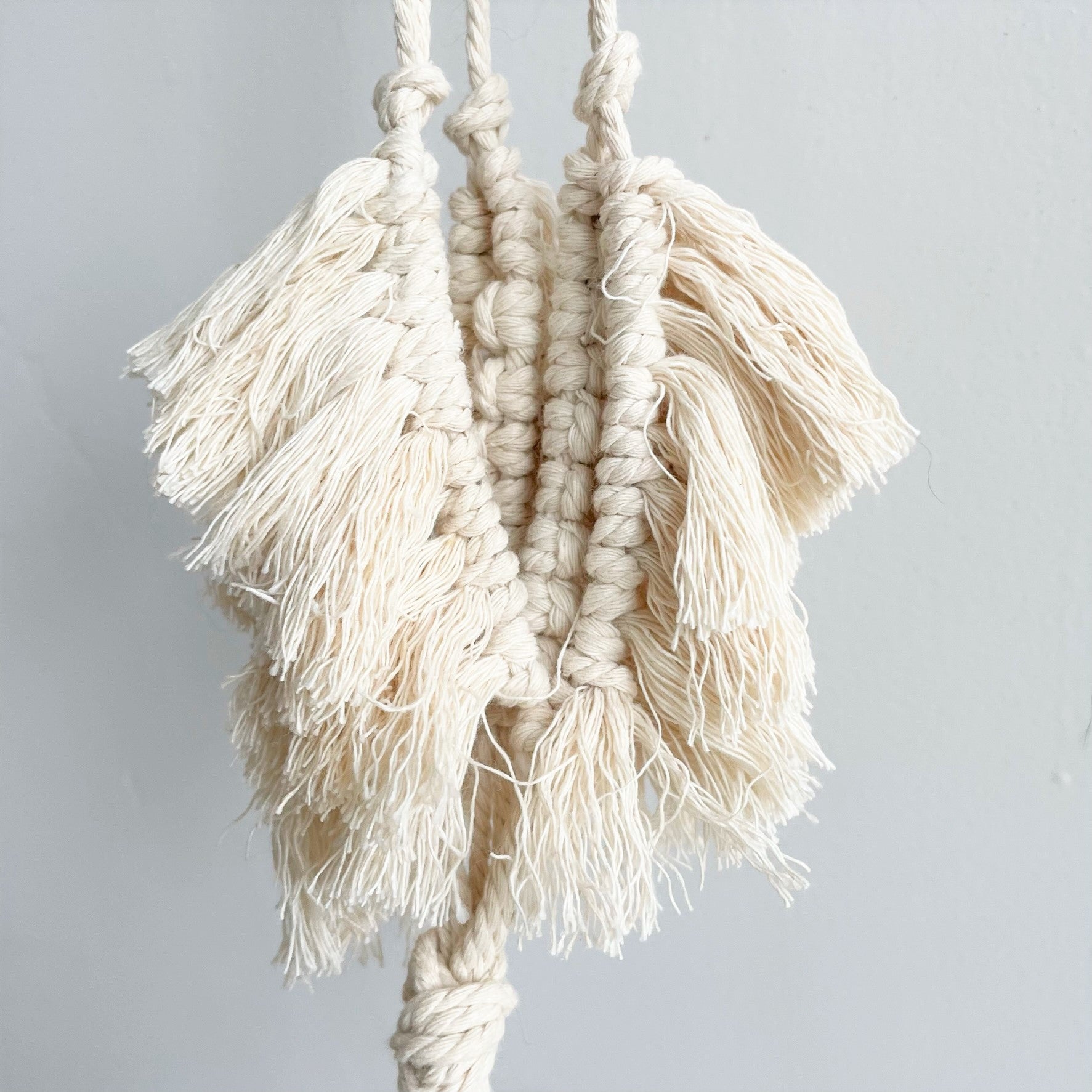 white rope plant hanger White Macramé Plant Hanger with Tufting